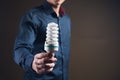 a man holding an ecological light bulb