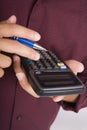 Man holding an electronic calculator