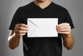 A man holding an envelope. Isolated on grey background Royalty Free Stock Photo