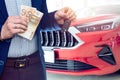 Man holding euro banknote for buy or rent new car at showroom Royalty Free Stock Photo