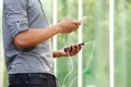 Man holding external battery and smart phone Royalty Free Stock Photo