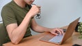 Man holding eyeglasses and working with laptop at home. Royalty Free Stock Photo