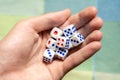 Man holding a few small game dice showing different numbers in hand, group of objects closeup. Math randomness, entropy,