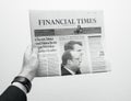 Man holding Financial Times newspaper with Emmanuel Macron on first page cover