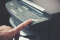 Man holding finger on start button of  printer Royalty Free Stock Photo