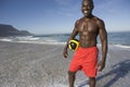 Man Holding Football On Beach