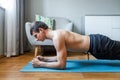 Man holding forearm plank pose doing yoga at home Royalty Free Stock Photo