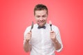 Man holding fork and knife on hand ready to eat, licking lips