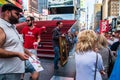 Man holding a framed painting of the Mona Lisa and showing it to tourists standing on line to buy show tickets on Broadway in New