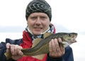 Man holding fresh cod fish Royalty Free Stock Photo