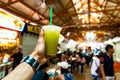 Man holding freshly squeezed sugar cane juice in plastic cup Royalty Free Stock Photo