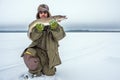 Grown man with a mustache and beard, holding a fish pike trophy fish catch in the winter. winter sports winter fishing Royalty Free Stock Photo