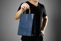 Man holding a gift bag. Close up. Isolated on grey background Royalty Free Stock Photo