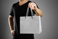 Man holding a gift bag. Close up. Isolated on grey background Royalty Free Stock Photo