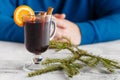 Man holding glass cup of delicious Christmas mulled wine in hand Royalty Free Stock Photo