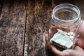 Man holding a glass jar for donations box