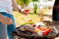 Man cooking meat and vegetables on barbecue grill outdoors Royalty Free Stock Photo