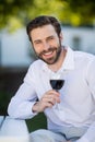 Man holding glass of wine in the park Royalty Free Stock Photo