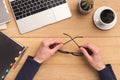 Man holding glasses while working on laptop Royalty Free Stock Photo