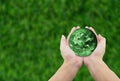 man holding globe with hands on grass background. Royalty Free Stock Photo