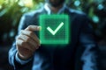 Man holding glowing check mark symbol, representing compliance and certification professional setting, conveying confidence