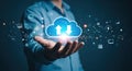 Man holding glowing cloud icon with upload and download arrows, representing cloud computing and data transfer Royalty Free Stock Photo