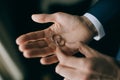 The man is holding a gold wedding ring. Wedding accessories Royalty Free Stock Photo