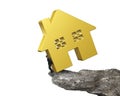 Man holding golden house on cliff edge Royalty Free Stock Photo