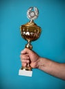 Man holding a golden trophy