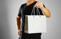 A man holding a gray gift bag. Close up. Isolated background Royalty Free Stock Photo