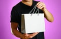 A man holding a gray gift bag. Close up. Isolated background Royalty Free Stock Photo