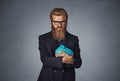 Man holding with greedy hand gesture the piggy bank Royalty Free Stock Photo