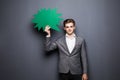 Man holding green blank speech bubble with space for text on grey background Royalty Free Stock Photo
