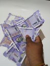 Man Holding Group of New Purple Color Indian Hundred Rupees Note Holding