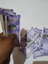 Man Holding Group of New Purple Color Indian Hundred Rupees Note Holding