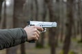 A man is holding a gun and aiming. A hand holding a gun about to shoot with a pistol Royalty Free Stock Photo