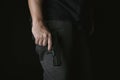Man holding gun close to the body, Killer with 9mm handgun pistol waiting for robbing the victim. Royalty Free Stock Photo