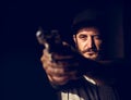 Man holding a gun wth black background