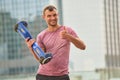 Man holding gyroboard, thumb up.