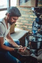 Man holding in hand coffee beans which he roasted