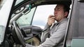 Man holding hand microphon and talking on radio in his car.