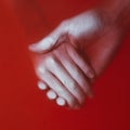 Man holding the hand of a woman in the red blood water, couple relationship, the concept of the price of love
