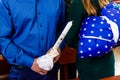 Man, holding in hands candles and a baby at the christening in Catholic Church