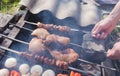 Man holding in hands grilled vegetables, chicken and pork meat on the open fire. Onions, mushrooms, tomatoes and red pepper on the Royalty Free Stock Photo