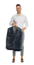 Man holding hanger with jacket in plastic bag on background. Dry-cleaning service Royalty Free Stock Photo