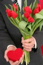 Man Holding Heart Shaped Box and Flowers Royalty Free Stock Photo