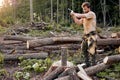 Man holding heavy ax. Axe in lumberjack hands chopping or cutting wood trunks Royalty Free Stock Photo