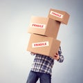Man holding heavy fragile cardboard boxes relocation, moving house or courier delivery