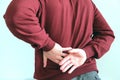 A man holding his back an attack of renal colic. Urolithiasis. The concept of health