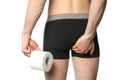 Man holding his butt and toilet paper, isolated on background Royalty Free Stock Photo